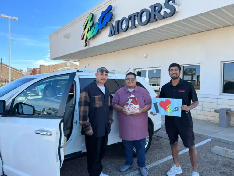 Grateful customer with dealership staff after buying a car.