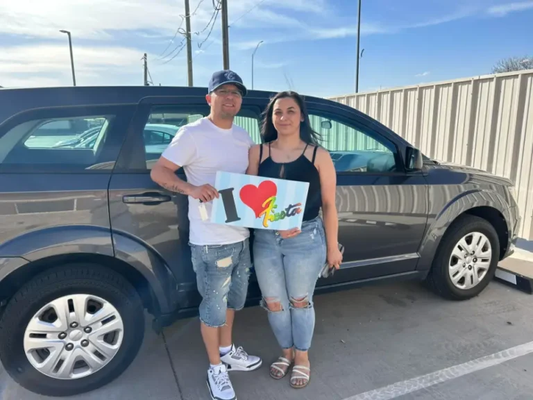 Happy family celebrating their car purchase at the dealership.